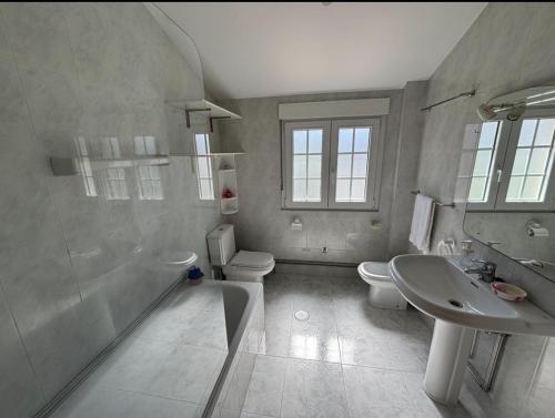 a bathroom with a sink and a shower and a toilet at Carnota Beach in Carnota