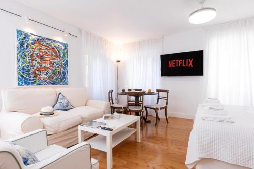 a living room with a couch and a table at Ventoura Suites, Corfu Old Town in Corfu