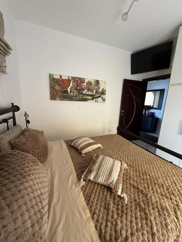 a bedroom with a large bed and a window at Katsaras House 3 Cozy Bedrooms in Kremasti