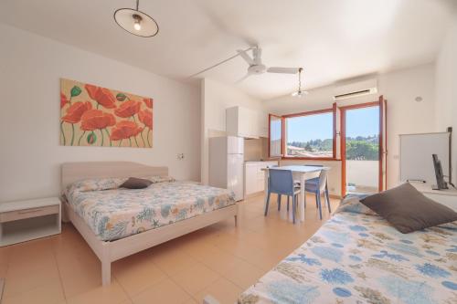 Katil atau katil-katil dalam bilik di Appartamenti Gli Orizzonti - Goelba