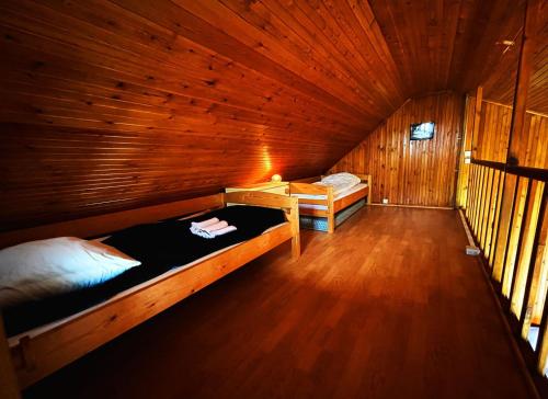 a room with two beds in a wooden cabin at chalet in a quiet area, total disconnection in Ploubazlanec