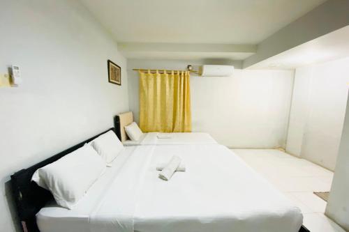 Ένα ή περισσότερα κρεβάτια σε δωμάτιο στο Hotel O Jodoh Near Grand Batam Mall Formerly Agung Hotel