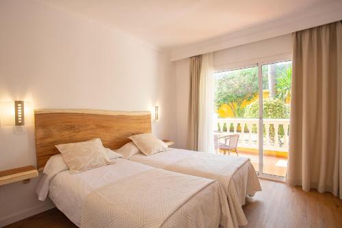 Postel nebo postele na pokoji v ubytování Hotel Cupidor