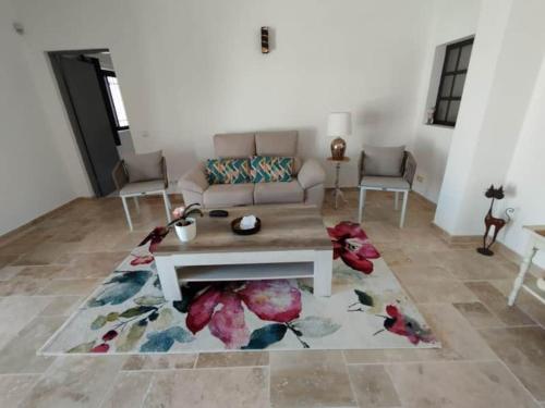 a living room with a couch and a coffee table at Quinta Azul in Loulé