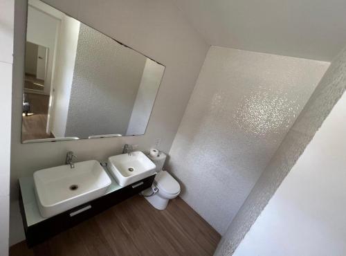 a bathroom with a sink and a mirror and a toilet at bavaro Punta Cana Beach club in Punta Cana