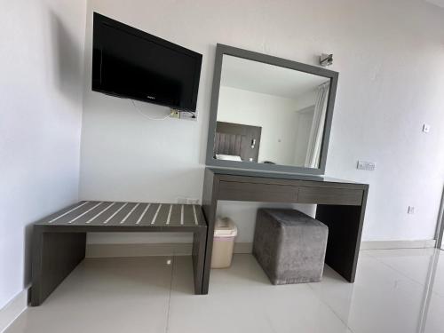 a bathroom with a desk with a mirror and a bench at Napa Jay Hotel in Ayia Napa