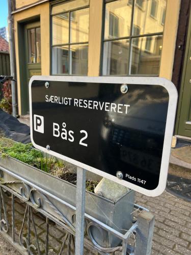 a street sign in front of a building at Visit wonderful Odense center - 3 bedroom appartment in Odense