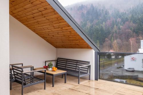 a room with a table and chairs and a large window at ApartView Plażowa Residence Szczyrk by Rent like home in Szczyrk