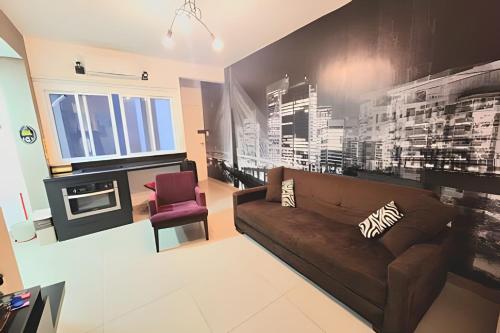 a living room with a brown couch and a fireplace at 2 DTS - Bela Vista - espaçoso + aconchegante in Sao Paulo