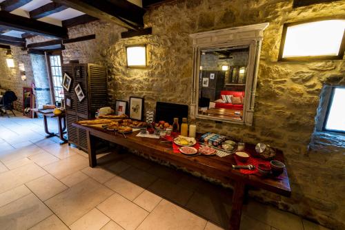 a table in a stone room with food on it at Domaine de la Pommeraye & Spa in La Pommeraye