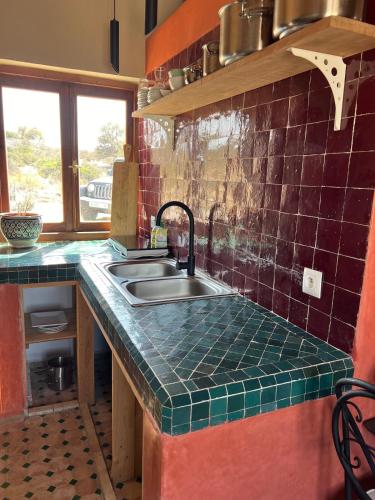 a kitchen with a sink and a counter top at The Ocean Breeze bungalow in Sidi Kaouki