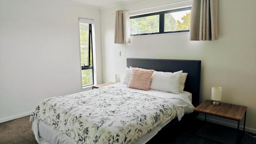 a bedroom with a bed and a window at Cheerful Spanking New House with 3 Bds 2 and half Bath in Hamilton