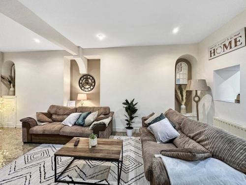 a living room with two couches and a table at 3 Bed Home In Tonypandy With Balcony View Room in Llwyn-y-pia