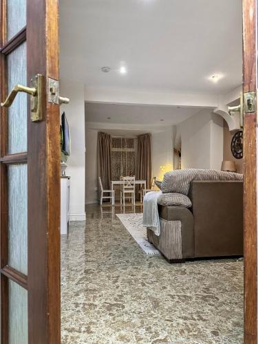 a living room with a couch and a table at 3 Bed Home In Tonypandy With Balcony View Room in Llwyn-y-pia