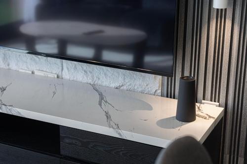a vase sitting on a table next to a window at The Cloud 9 Penthouse by Blue Cloud Holidays in Sharjah Intl