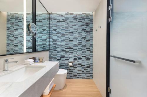 a bathroom with a sink and a toilet and a shower at Fairfield by Marriott Hangzhou Gongshu in Hangzhou