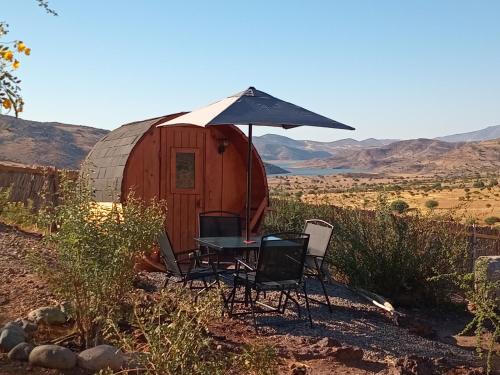 a table and chairs in front of a yurt at Ecoturismo El Refugio en La Colorada, Combarbalá in Combarbalá