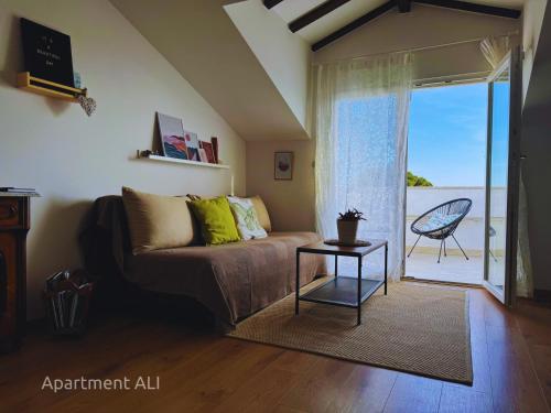 a living room with a couch and a table at Apartments ALI & EL - perfect for couples in Rovinj