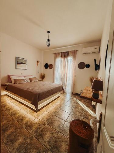 a bedroom with a large bed in a room at Naxian Sofias garden in Naxos Chora