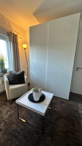 a living room with a table with a cake on it at HARMONY "2" stylishes 2 Zimmer Apartment 1 OG Balkon Garten Parkplatz in Gütersloh