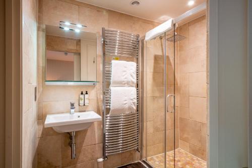 a bathroom with a sink and a shower at The Northey Arms in Box