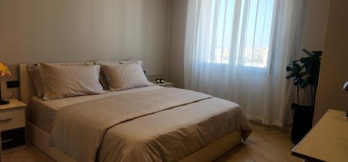 Ένα ή περισσότερα κρεβάτια σε δωμάτιο στο Grid Apartment