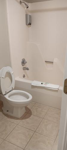 Un baño con un inodoro blanco en una habitación. en Americana Inn - Henderson, en Henderson