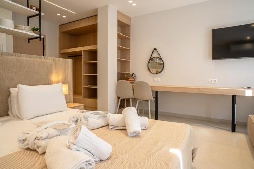 a bedroom with a bed with towels on it at Urban Athens Gem in Athens