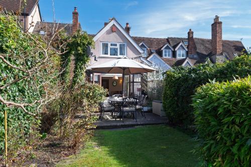 a house with a patio with an umbrella at Toad Hall in Ludlow