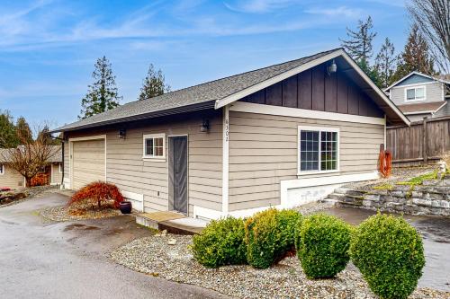 a small house with a driveway in front of it at The Cozy Nook in Bonney Lake