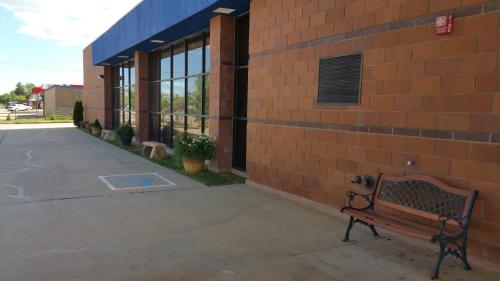 a bench sits outside of a brick building at Inn at the Canyons in Monticello
