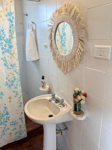 a bathroom with a sink and a mirror on the wall at Nani 1 in Concordia