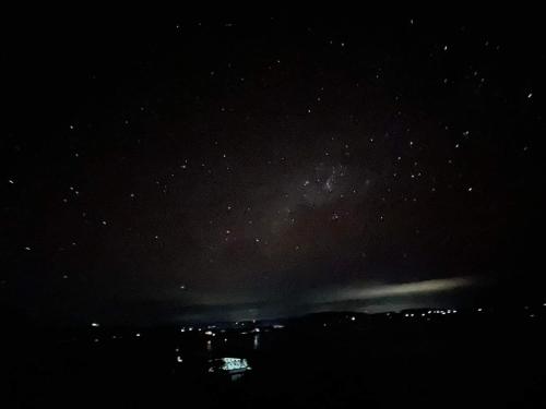 a starry night with the milky way in the sky at A & L Resort - Sea & Mountain View in Looc
