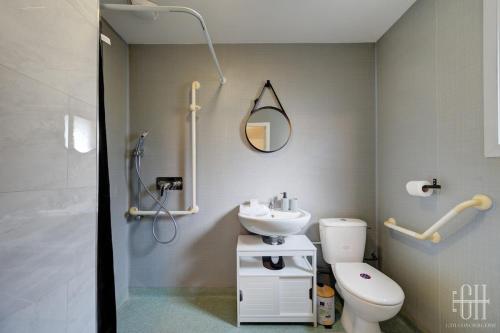 ein Badezimmer mit Toilette, Waschbecken und Spiegel in der Unterkunft Mercure - Proche A10 -2 V -Parking- Rez-de-chaussée in Saint-Pierre-des-Corps