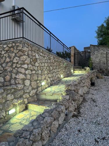 a stone wall with stairs with lights on it at Villa Baglio della Fico a 15 minuti dalla valle dei templi e dal mare in Racalmuto