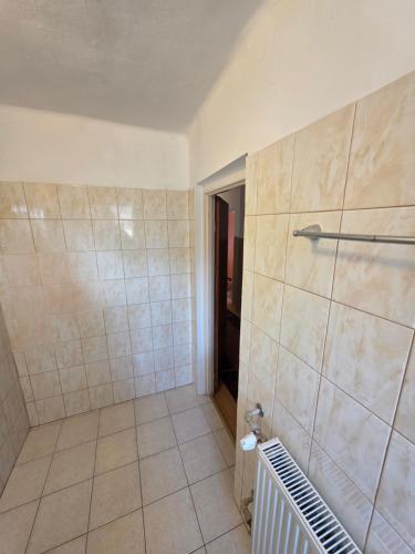 a bathroom with a shower with a tiled floor at Willa pod Babkami in Tylicz
