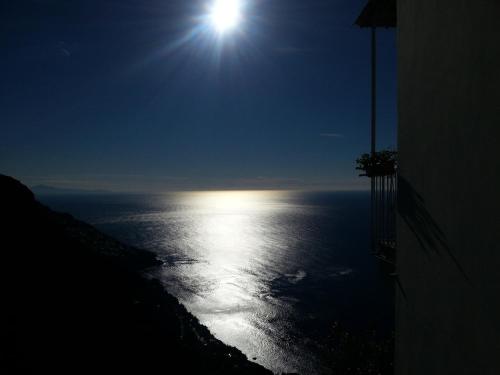 a view of the ocean at night with the moon at Villa Antica Macina in Positano
