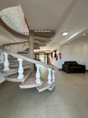 a lobby with a spiral staircase in a building at Porto Marina Resort in Ilha Comprida