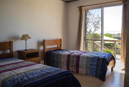 a bedroom with two beds and a large window at Océano Puro in José Ignacio