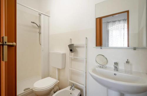 a bathroom with a sink and a toilet and a mirror at Casale dello Zio, private pool by IL PUMO DI PUGLIA in Castellana Grotte