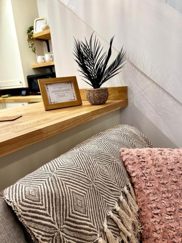 a room with a wooden shelf with a potted plant at Entire home in Eccleshall in Eccleshall