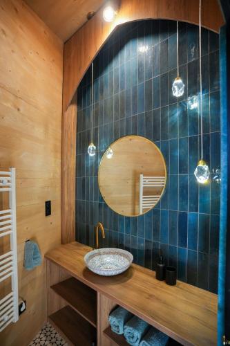 a bathroom with a sink and a mirror at Villa Marrakesh Noszvaj in Noszvaj