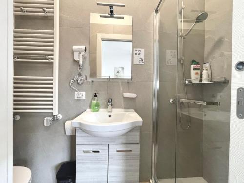 a bathroom with a sink and a shower at Marco Polo House in Mestre