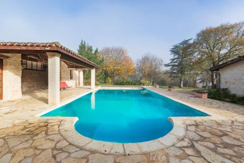 a swimming pool with blue water in a yard at Domaine du Bilé - Piscine et Jacuzzi privés in Solomiac