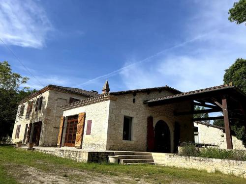 an old stone building with a cross on top at Domaine du Bilé - Piscine et Jacuzzi privés in Solomiac