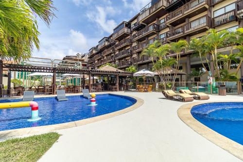 a resort with a pool and a hotel at Conforto à Beira-Mar no Condomínio Barra Bali - Destino 327 in Barra de São Miguel