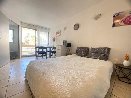 - une chambre avec un grand lit et une salle à manger dans l'établissement Canet appartement à 100 m de la plage avec parking, à Canet