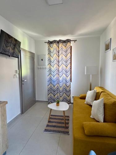 a living room with a yellow couch and a table at Apartmány TAMKA in Vrbov