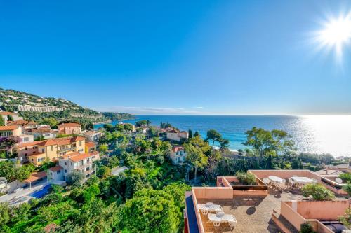 an aerial view of a town with the ocean at Résidence "Le Golfe Bleu" in Roquebrune-Cap-Martin