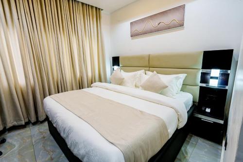 a bedroom with a large bed in a room at Roston Hotels in Port Harcourt